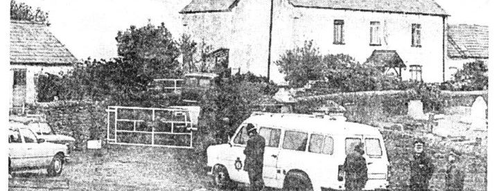 Newspaper photograph: police wait outside the farmhouse, April 1988